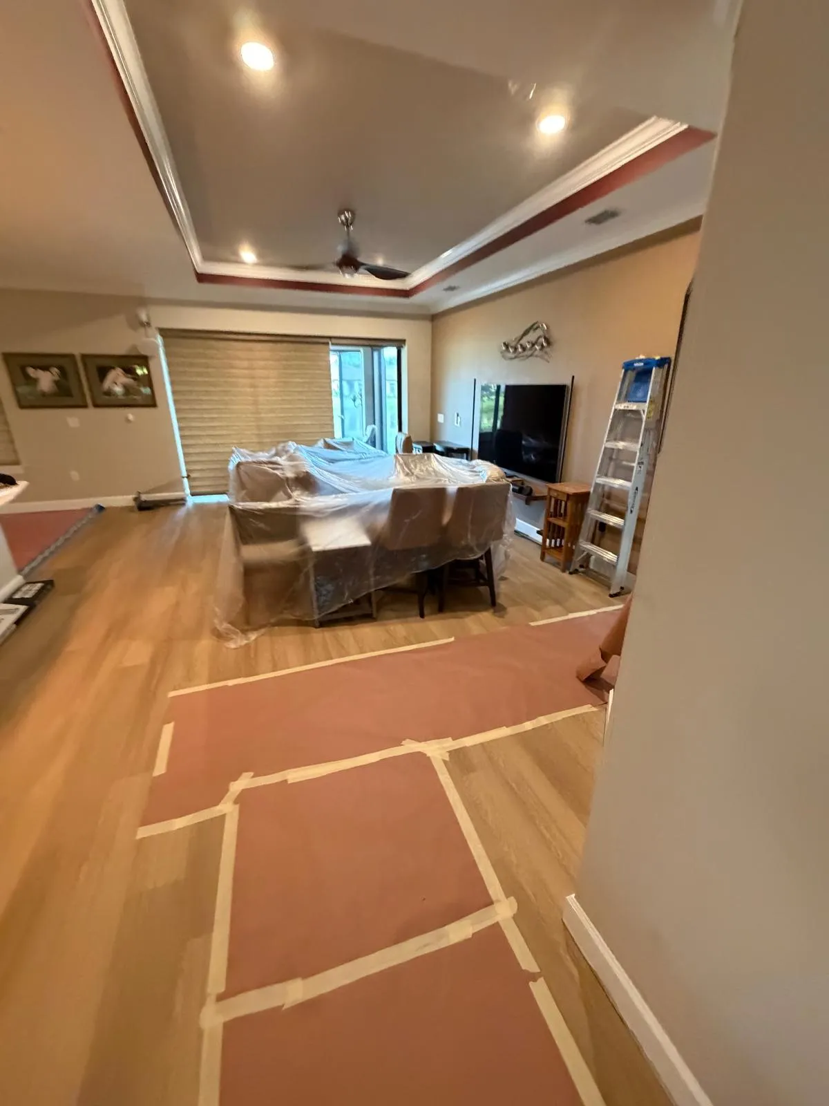 Living room during LVP flooring installation in Esplanade at Wiregrass Ranch, Wesley Chapel, FL
